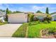 Charming single-story home with well-maintained landscaping and an attached two-car garage at 4251 Whittner Dr, Land O Lakes, FL 34639
