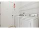 Functional laundry area with modern washer, dryer, and white wire shelving for convenient storage at 4251 Whittner Dr, Land O Lakes, FL 34639