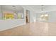 Large, open living room featuring lots of tile floor, light colored walls, and arched doorways at 4251 Whittner Dr, Land O Lakes, FL 34639