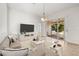 A spacious living room with tile floors, lots of light, a large television, and neutral decor at 4251 Whittner Dr, Land O Lakes, FL 34639