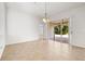 Bright living room featuring neutral tile flooring and sliding glass doors leading to the outside patio at 4251 Whittner Dr, Land O Lakes, FL 34639