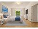 Cozy main bedroom features a plush bed, tile floors, a large window, and ample natural light at 4251 Whittner Dr, Land O Lakes, FL 34639