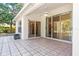 Covered tiled patio with sliding glass doors to the kitchen and living spaces at 4251 Whittner Dr, Land O Lakes, FL 34639