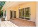 An outdoor patio with tile flooring, ceiling fan, and sliding glass doors overlooking the backyard at 4251 Whittner Dr, Land O Lakes, FL 34639