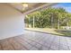 Tiled patio area with ceiling fan overlooking the backyard and mature trees at 4251 Whittner Dr, Land O Lakes, FL 34639