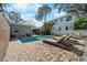 Backyard featuring a sparkling pool, lounge chairs, and a brick-paved patio area at 710 S Davis Blvd, Tampa, FL 33606