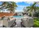 Relaxing backyard with a sparkling pool, lounge chairs, and patio seating for entertaining at 710 S Davis Blvd, Tampa, FL 33606