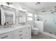 Bathroom featuring double sinks, tiled shower, and modern fixtures at 710 S Davis Blvd, Tampa, FL 33606