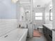Beautifully remodeled bathroom with soaking tub, tiled shower, modern vanity at 710 S Davis Blvd, Tampa, FL 33606