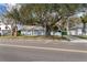 Charming blue brick home featuring a covered front porch with white columns and mature trees at 710 S Davis Blvd, Tampa, FL 33606