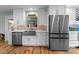 Kitchen featuring stainless steel appliances, white cabinetry, and quartz countertops at 710 S Davis Blvd, Tampa, FL 33606
