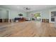 Bright living room featuring hardwood floors, a ceiling fan, and a large sliding glass door to the backyard at 710 S Davis Blvd, Tampa, FL 33606