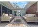 Covered patio with brick flooring and comfortable outdoor furniture creating a cozy and inviting space at 710 S Davis Blvd, Tampa, FL 33606