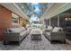 Inviting outdoor patio space with comfortable seating, brick pavers and backyard pool views at 710 S Davis Blvd, Tampa, FL 33606