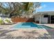 Backyard with a refreshing swimming pool surrounded by brick pavers and lush landscaping at 710 S Davis Blvd, Tampa, FL 33606