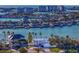Stunning aerial view of waterfront home with lush landscaping and ocean view of the city skyline in the background at 7810 10Th S Ave, St Petersburg, FL 33707