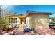 Quaint single-story home featuring a cheerful orange door, mature plants and a cozy, inviting walkway at 830 S Davis Blvd, Tampa, FL 33606