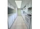 Bright white kitchen featuring appliances, sleek countertop, and ample cabinet space at 8608 Lake Isle Dr # 0, Temple Terrace, FL 33637