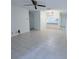 Bright living room with tile flooring, ceiling fan, and a pass-through to the kitchen at 8608 Lake Isle Dr # 0, Temple Terrace, FL 33637