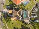 Aerial view of a property with a tile roof, screened pool, and private dock, showcasing waterfront living at 952 Symphony Isles Blvd, Apollo Beach, FL 33572