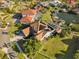 Aerial view showcases a home with a screened pool, well-kept lawn and tile roof in a desirable neighborhood at 952 Symphony Isles Blvd, Apollo Beach, FL 33572