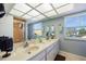 Bright bathroom featuring double sinks, a large mirror, and a glass-door shower at 952 Symphony Isles Blvd, Apollo Beach, FL 33572