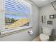 Cozy bathroom featuring a toilet, art, and a window for ample natural light at 952 Symphony Isles Blvd, Apollo Beach, FL 33572