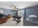 Bedroom boasts a foosball table, desk, and balcony access at 952 Symphony Isles Blvd, Apollo Beach, FL 33572