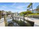 Boat dock with lift on a sunny day at 952 Symphony Isles Blvd, Apollo Beach, FL 33572