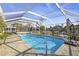Backyard pool with a screened-in enclosure and waterfront views at 952 Symphony Isles Blvd, Apollo Beach, FL 33572