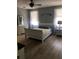 Serene bedroom with a white sleigh bed, matching dresser and nightstand, and soft natural light, offering a peaceful retreat at 1314 Riserva Ln, Palm Harbor, FL 34683