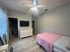Bedroom with neutral colors, closet, dresser, and a ceiling fan offering a simple and comfortable living space at 1314 Riserva Ln, Palm Harbor, FL 34683