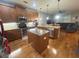 A spacious kitchen with wooden cabinets, stainless steel appliances, granite countertops, and an island is perfect for cooking at 1314 Riserva Ln, Palm Harbor, FL 34683