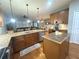 Open kitchen featuring granite countertops, stainless steel appliances, and seamless flow to living and dining areas at 1314 Riserva Ln, Palm Harbor, FL 34683