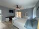 A bright main bedroom featuring a bed, desk, dresser, and ceiling fan, creating a relaxing and functional space at 1314 Riserva Ln, Palm Harbor, FL 34683