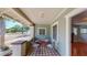 Inviting porch with decorative tile floor, seating, and a view of the neighborhood at 2418 2Nd S Ave, St Petersburg, FL 33712