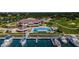 Aerial shot of the community featuring the clubhouse, pool, marina, and golf course in a picturesque waterfront setting at 2775 Kipps Colony S Dr # 105, Gulfport, FL 33707