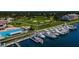 An aerial shot of a marina with boats, a pool area, and nearby golf course, showcasing a waterfront community at 2775 Kipps Colony S Dr # 105, Gulfport, FL 33707