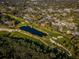 Aerial shot of a golf course, pond, and residential area showing the layout of the community from above at 2775 Kipps Colony S Dr # 105, Gulfport, FL 33707