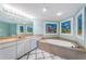Bright bathroom with a large vanity, bathtub, and decorative artwork at 2775 Kipps Colony S Dr # 105, Gulfport, FL 33707
