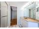 Bathroom featuring a tile shower, vanity with a light countertop, and access to the main bedroom at 2775 Kipps Colony S Dr # 105, Gulfport, FL 33707