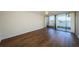 This bright bedroom offers wood floors, a ceiling fan and sliding glass door to the balcony at 2775 Kipps Colony S Dr # 105, Gulfport, FL 33707