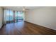 The primary bedroom has wood floors, fan and sliding glass doors with waterfront views at 2775 Kipps Colony S Dr # 105, Gulfport, FL 33707