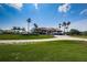 Beautiful clubhouse exterior surrounded by lush greenery and palm trees, offering a picturesque setting for recreation and relaxation at 2775 Kipps Colony S Dr # 105, Gulfport, FL 33707