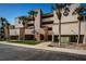 Close up of a waterfront condo building with manicured landscaping and clear blue skies at 2775 Kipps Colony S Dr # 105, Gulfport, FL 33707