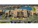 Waterfront condo complex with lush landscaping, community parking, and boat docks at 2775 Kipps Colony S Dr # 105, Gulfport, FL 33707