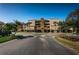 Condo building with a well-manicured front yard and community parking spaces at 2775 Kipps Colony S Dr # 105, Gulfport, FL 33707
