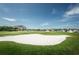 Golf course sand trap and the green with residences and boats beyond showing the community setting at 2775 Kipps Colony S Dr # 105, Gulfport, FL 33707