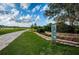 First tee box along golf course with stone marker showing distances, and a stone retaining wall with flower beds at 2775 Kipps Colony S Dr # 105, Gulfport, FL 33707