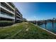 Exterior view along the waterway highlighting a boat dock and manicured grounds at 2775 Kipps Colony S Dr # 105, Gulfport, FL 33707